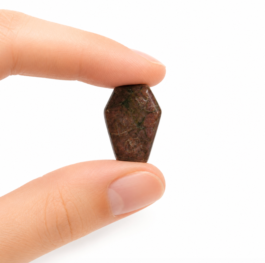 Mini coffin-shaped gemstone, polished with natural color variation